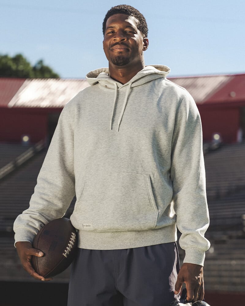 A man wearing a Rhoback hoodie